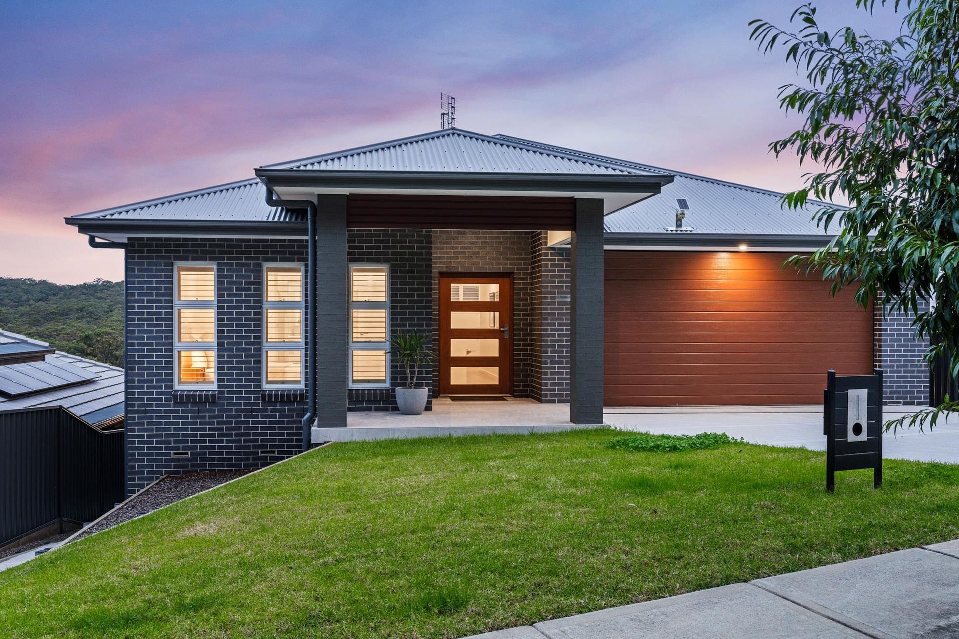 A large brick house with a brown garage door