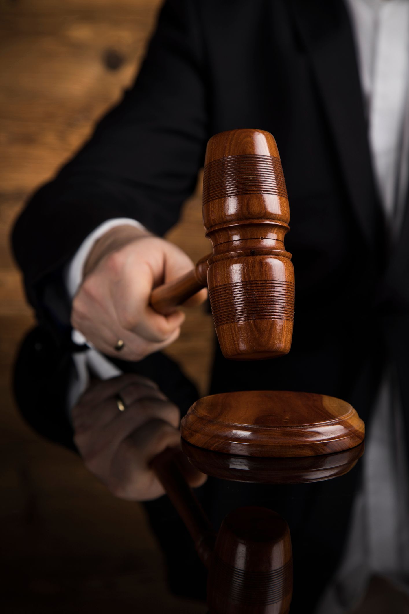 Spinal cord injury lawyer holding gavel, symbolizing justice and legal representation.