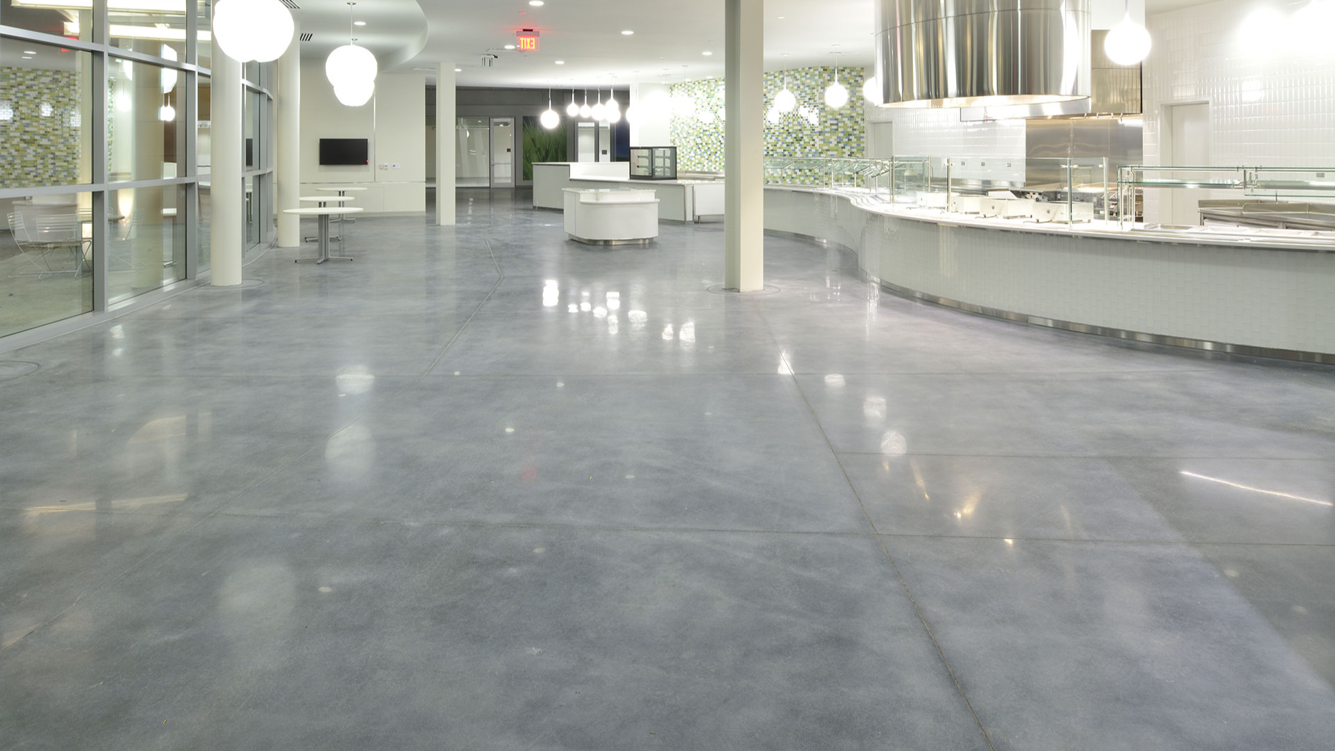 Welcome to Lime Flooring, the experts in Polished Concrete Flooring. If you're a business owner or decision maker looking to elevate your space with stylish and durable polished concrete flooring, you've come to the right place. In this informative article, we'll explore a variety of polished concrete flooring ideas for any business, helping you make an informed decision and create a lasting impression on your clients and employees.  Polished Concrete Flooring Ideas for Any Business  Why Choose Polished Concrete Flooring? Polished concrete flooring is gaining immense popularity among businesses for its unique blend of durability, low-maintenance requirements, cost-effectiveness, and eco-friendliness. With its sleek, seamless finish and versatile nature, polished concrete can enhance the aesthetic appeal of any space.  Create a Sleek Industrial Look: Polished concrete flooring perfectly complements industrial-style spaces, effortlessly blending with the raw and contemporary nature of industrial design. By opting for polished concrete, you can achieve a stunning amalgamation of industrial chic and modern elegance, perfect for any business looking to create an industrial-inspired atmosphere.  Enhance Your Retail Space: First impressions matter in the retail world, and polished concrete flooring can help you create a visually captivating environment that attracts customers and beautifully showcases your products. The reflective surface of polished concrete adds a touch of sophistication, creating a bright and inviting space that leaves a lasting impression on shoppers. Whether you run a boutique, a furniture showroom, or any other retail establishment, polished concrete flooring can elevate your space and enhance your brand image.  Impress in Corporate Settings: Polished concrete flooring makes a powerful statement in corporate offices and professional environments. Its seamless and polished surface exudes professionalism and cleanliness, creating a positive impression on clients and employees. Furthermore, the versatility of polished concrete allows for customization, enabling you to incorporate your company's branding through strategically placed colours, patterns, or logos. By installing polished concrete flooring in your reception area or conference rooms, you can achieve an elegant and contemporary look that reflects your company's professionalism and style.  Hospitality and Entertainment Spaces: Durability is crucial in the hospitality and entertainment industry, and polished concrete flooring delivers on that front. Able to withstand the rigours of high foot traffic, spills, and stains, polished concrete maintains its polished appearance even in the busiest of venues. Whether you own a restaurant, a hotel, or an entertainment venue, polished concrete flooring offers both style and practicality. Its attractive and easy-to-maintain nature allows you to focus on creating a visually captivating environment that enhances the overall experience for your guests.  Maintaining Polished Concrete Flooring: To ensure your polished concrete flooring remains in pristine condition, proper maintenance is essential. Regular sweeping, mopping, and occasional polishing will keep it looking its best. Additionally, using floor mats and furniture protectors can prevent scratches and dents, maintaining the longevity of your polished concrete flooring investment.  Conclusion: Transforming your business space with polished concrete flooring is an investment that brings numerous benefits. Its durability, low-maintenance requirements, and aesthetic appeal make it a top choice for businesses seeking a stylish and long-lasting flooring solution. At Lime Flooring, we take pride in delivering exceptional results tailored to your specific needs. Contact us today, and let our expertise and passion for polished concrete flooring help you create an environment that leaves a lasting impression on your clients and employees.