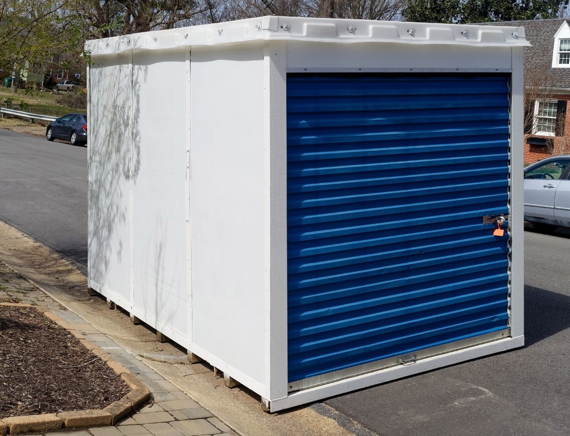 Temporary storage unit at curbside in residential neighborhood.