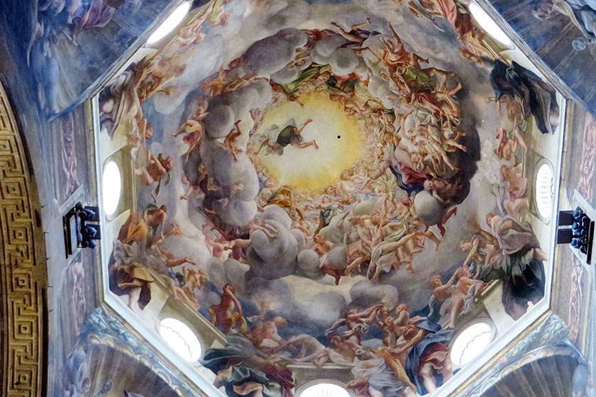 Ceiling fresco: swirling clouds, angels, and central bright light.