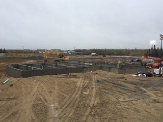 Un chantier de construction avec beaucoup de terre et beaucoup de machines.