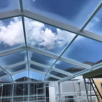 A glass roof with a blue sky behind it