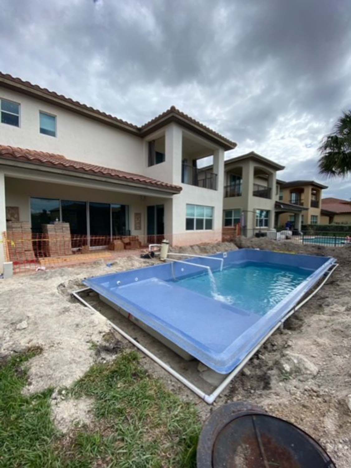 A large house with a swimming pool in front of it