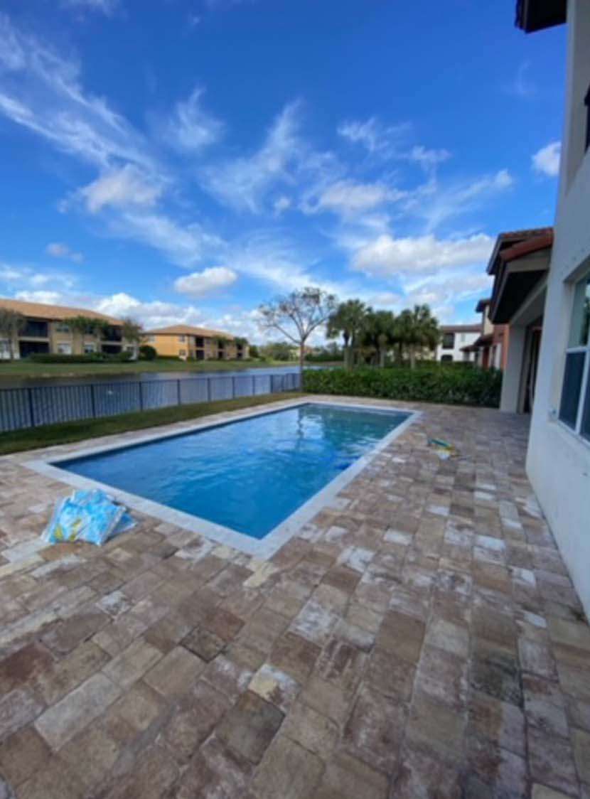 A large swimming pool in the backyard of a house