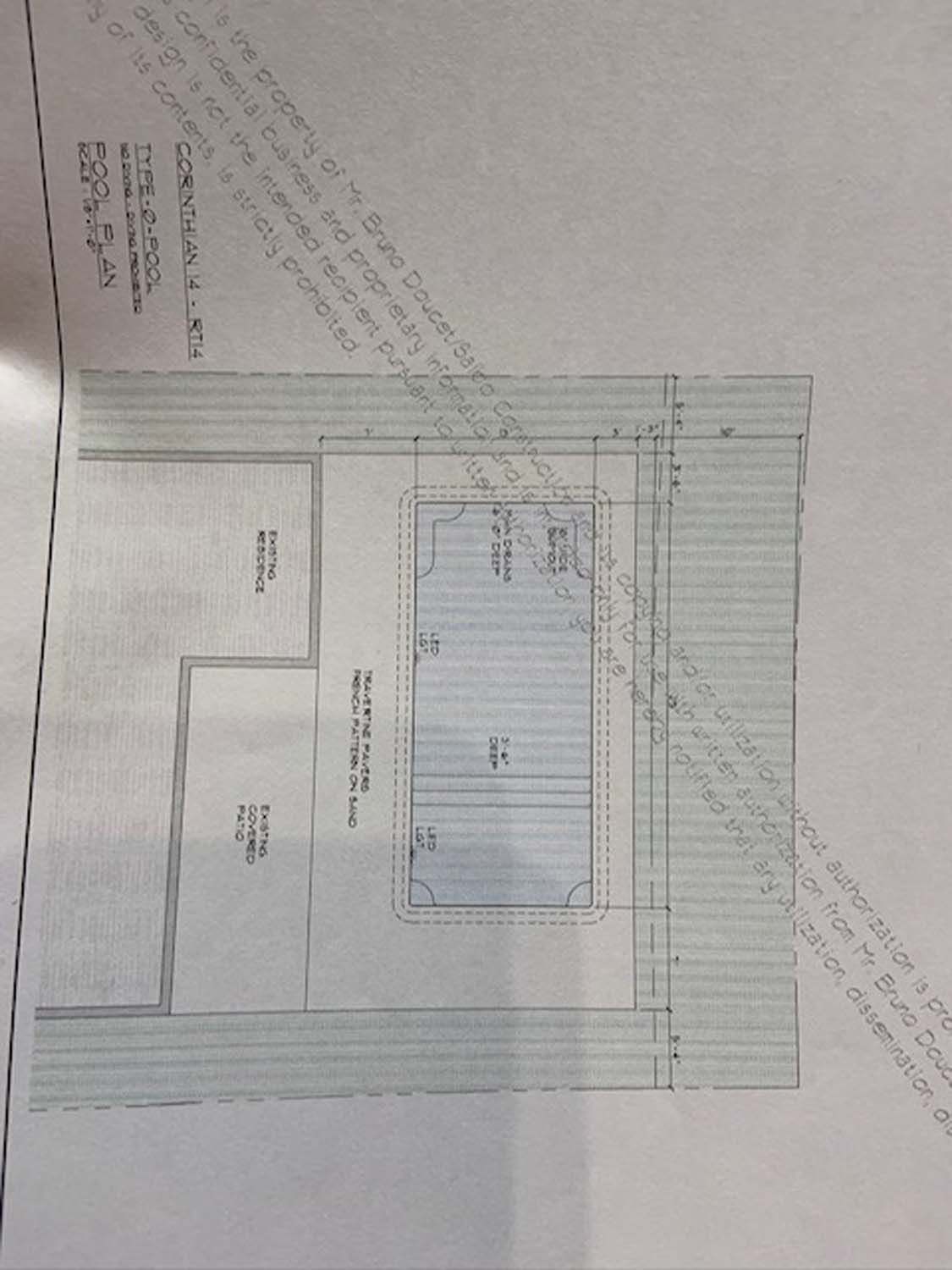A blue and white drawing of a room with measurements on a piece of paper.