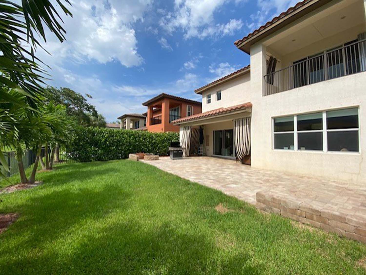 A large house with a large lawn in front of it.