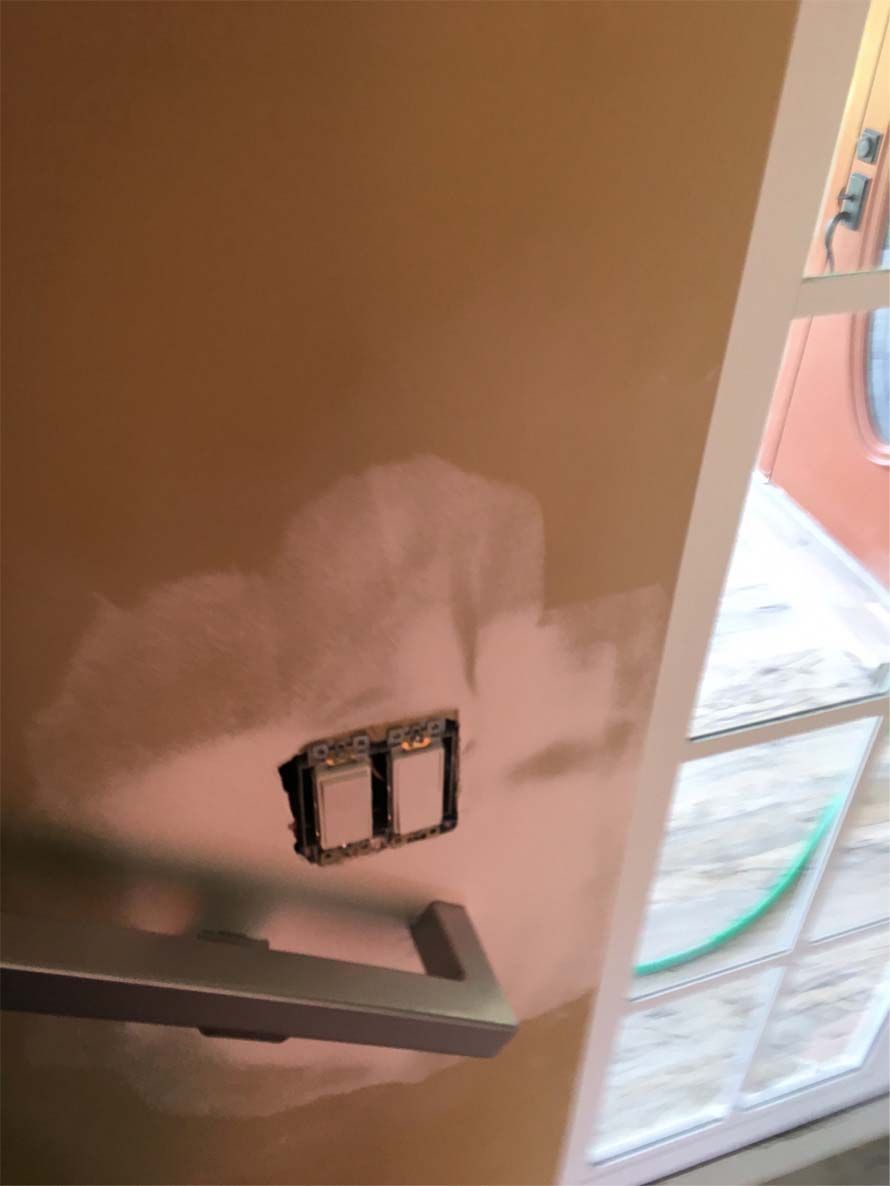 A close up of a door with a reflection of a window