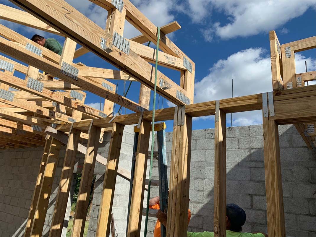 A man is standing on top of a wooden structure.