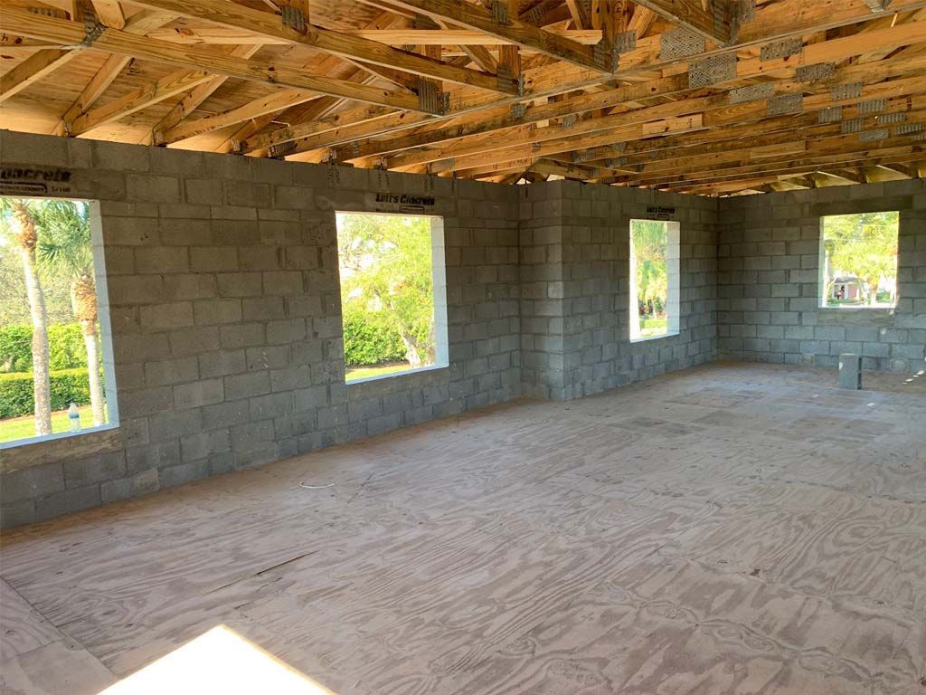 An empty room with brick walls and wooden beams.