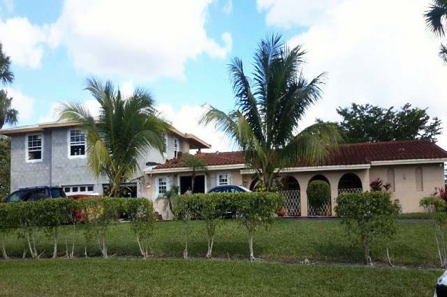 A large house with a car parked in front of it