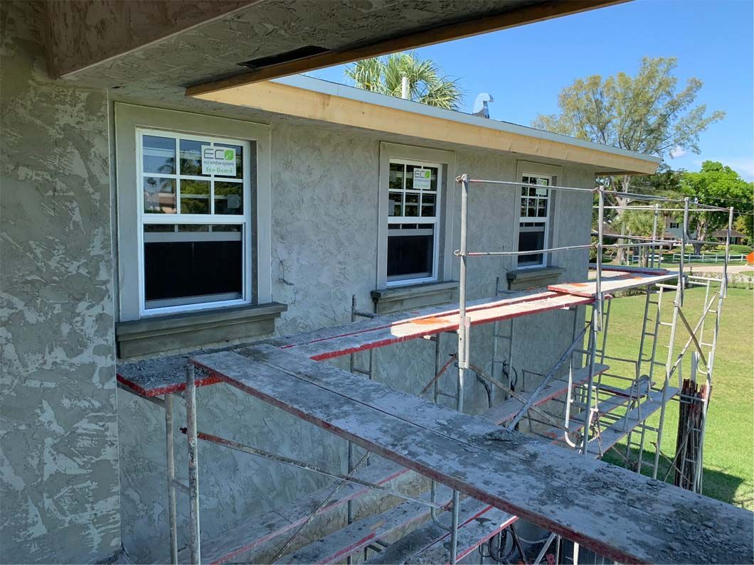 A house is being built with scaffolding around the windows.