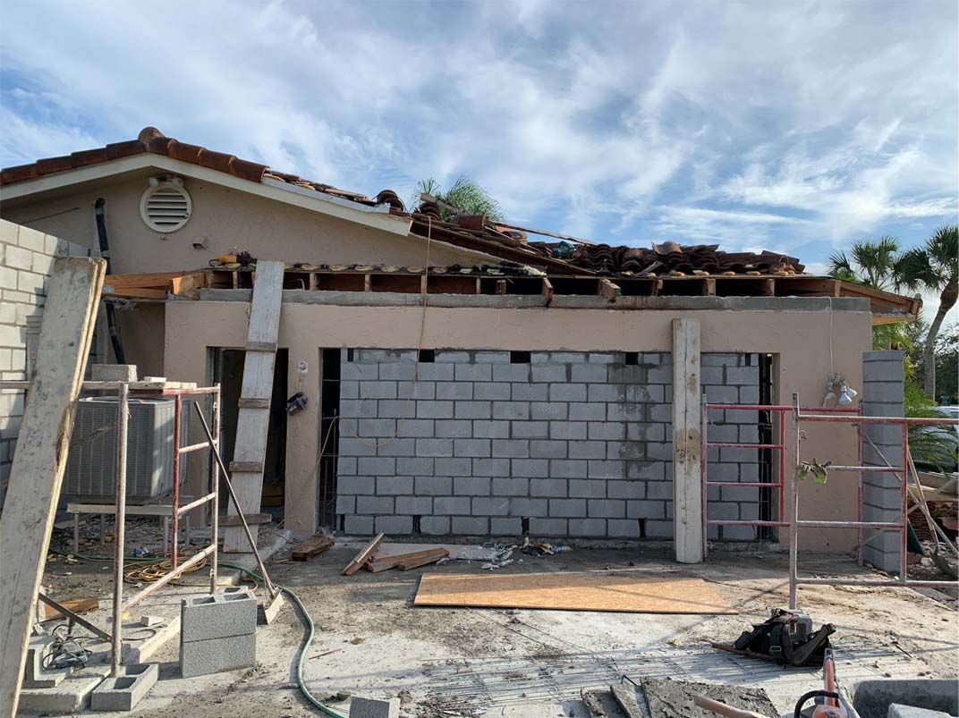 A house is being built with bricks and scaffolding.