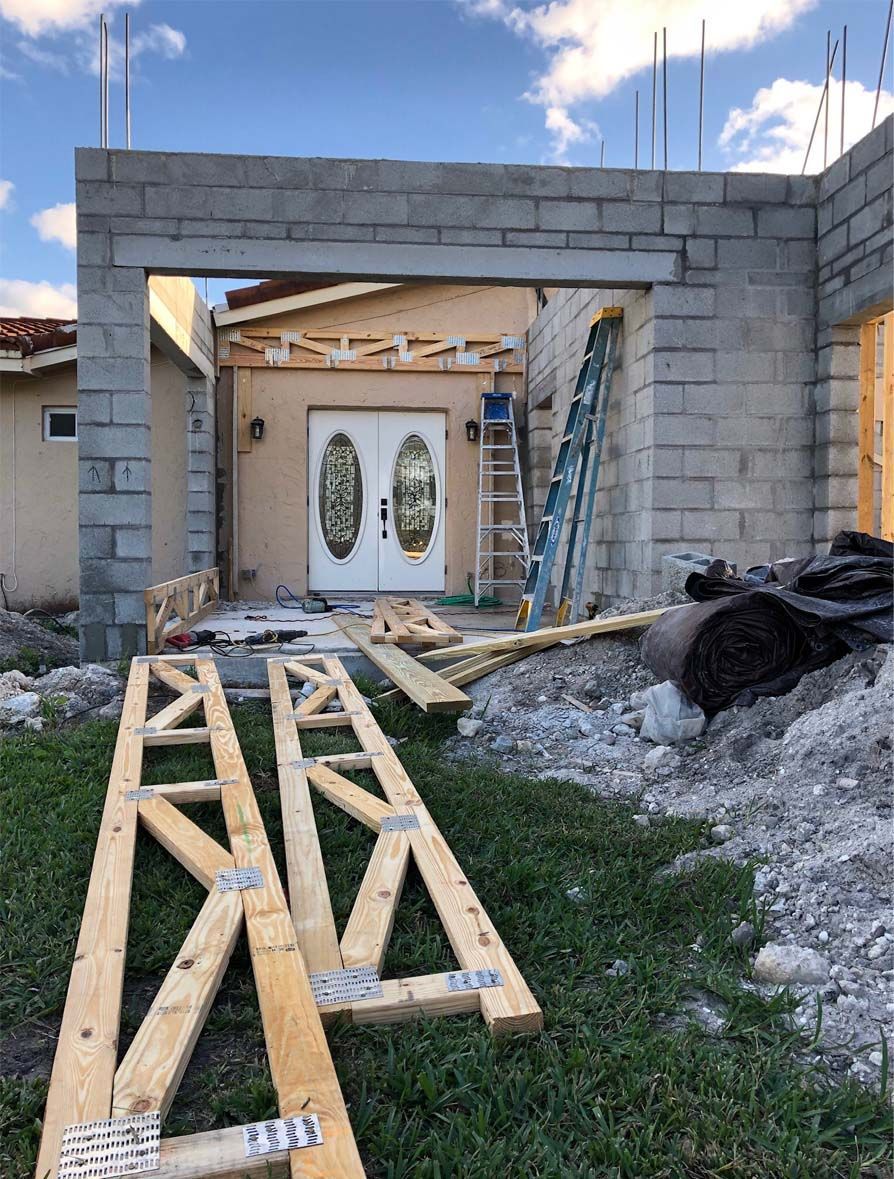 A house is being built with wooden beams in front of it.