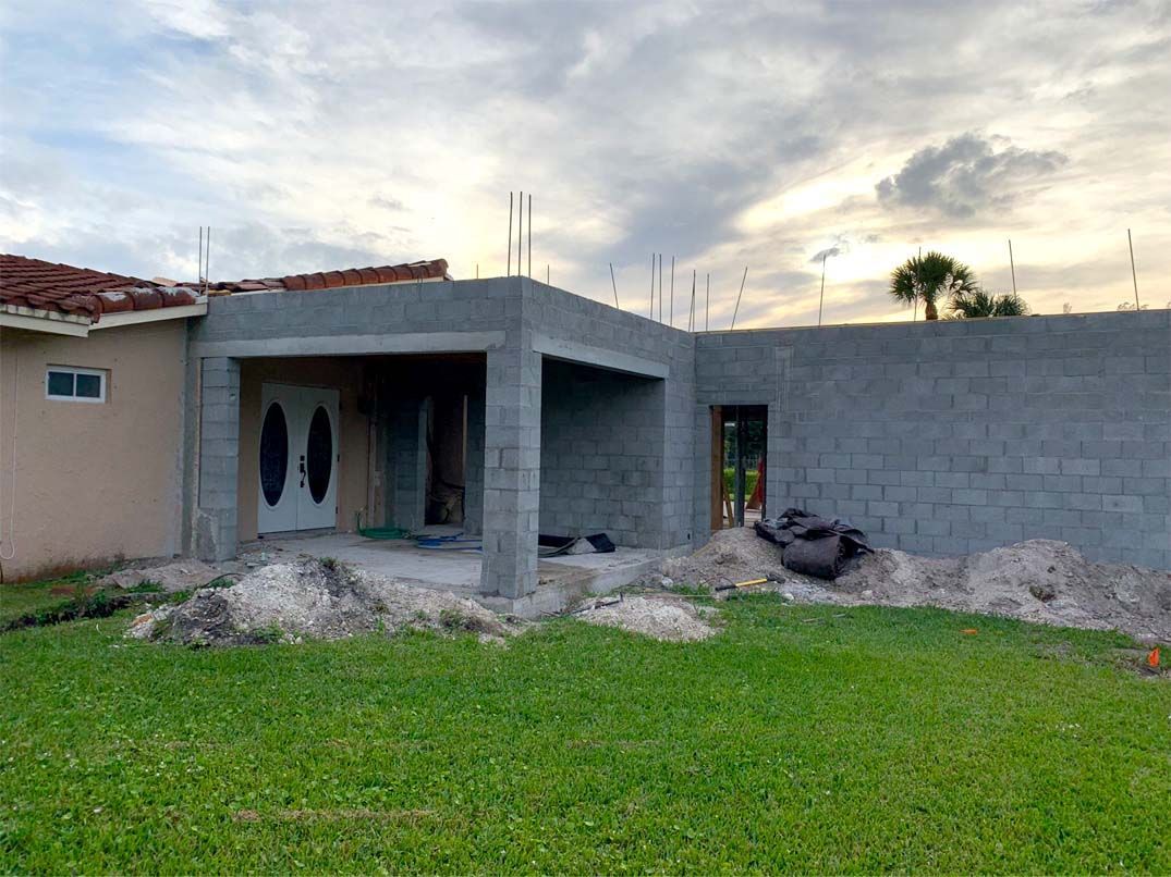 A house is being built with bricks in the backyard.