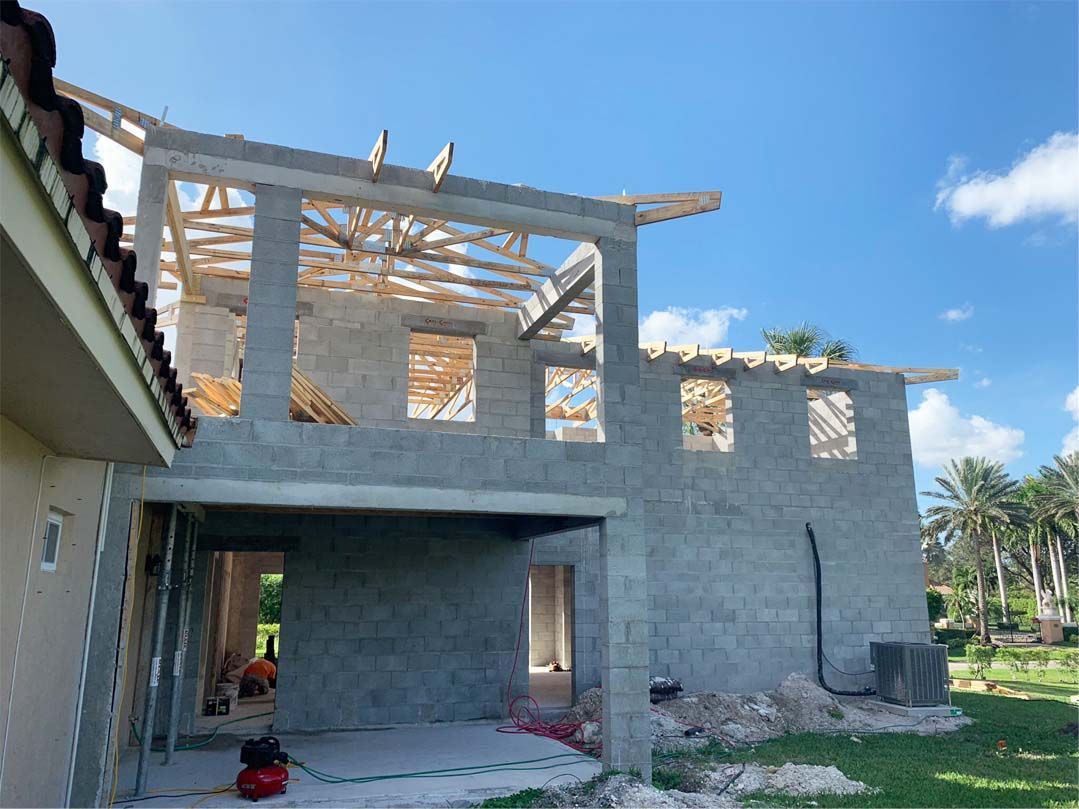 A house is being built with bricks and wooden beams.