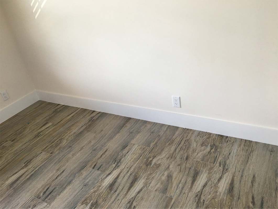 A room with a wooden floor and white walls.