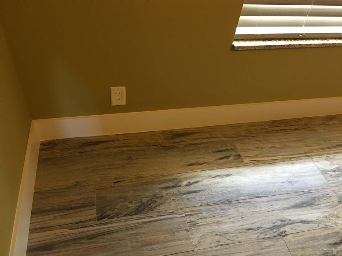 A room with a wooden floor and a window.