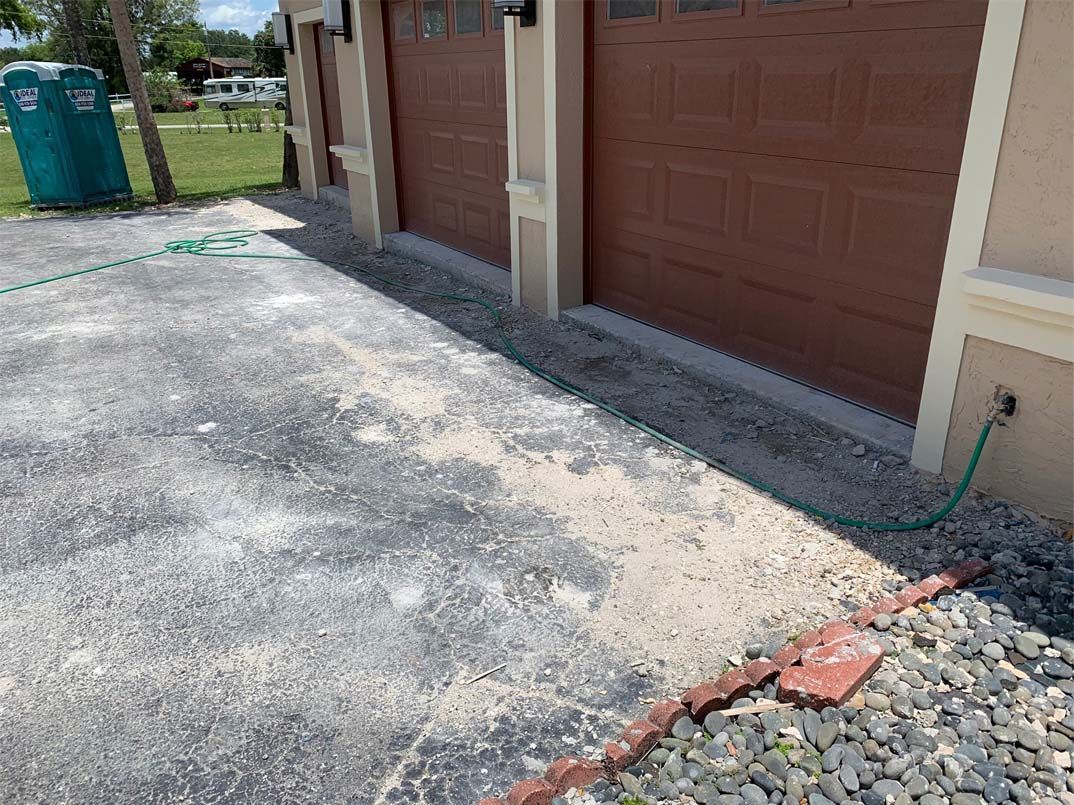 A hose is attached to the side of a garage door.