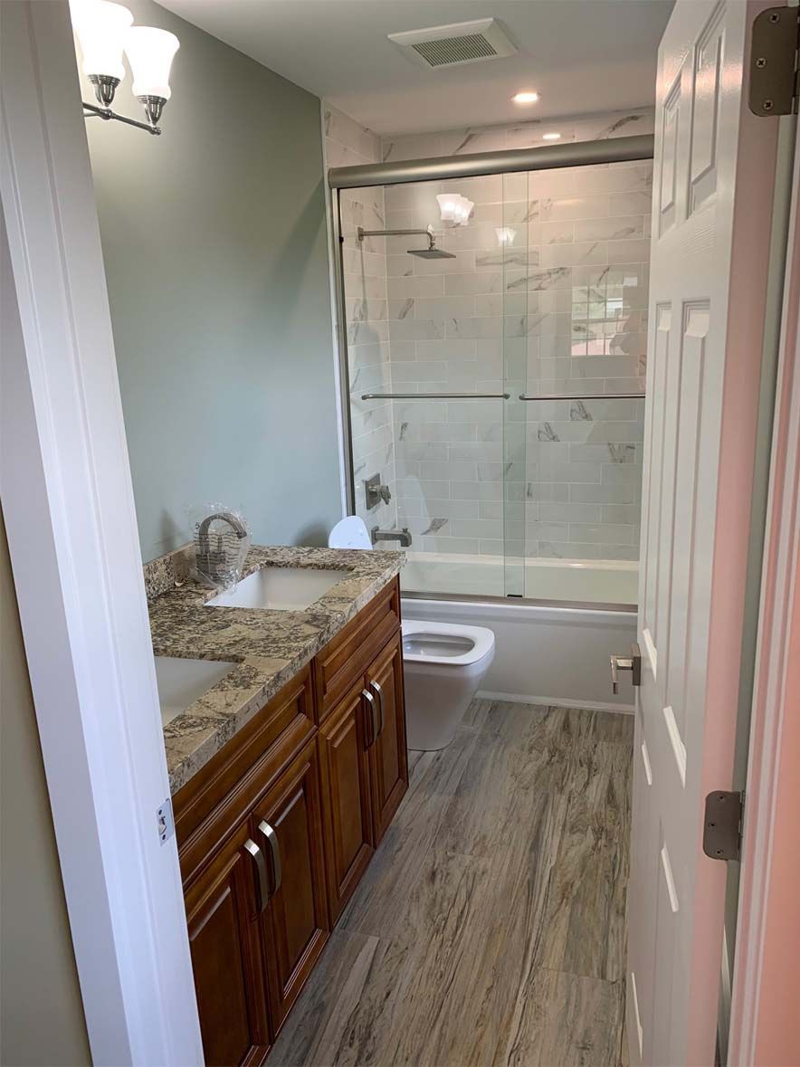 A bathroom with a sink , toilet , tub and shower.