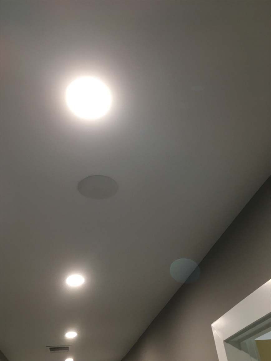 A hallway with a ceiling that has a lot of lights on it.