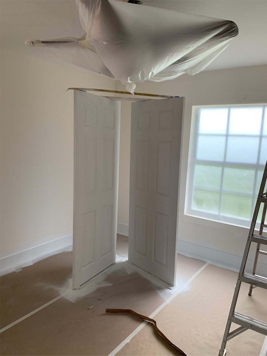 A room with two doors and a ladder in it