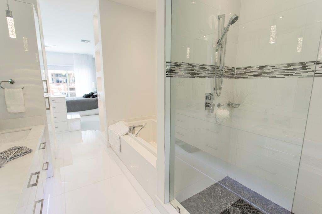 A bathroom with a walk in shower and a bathtub.