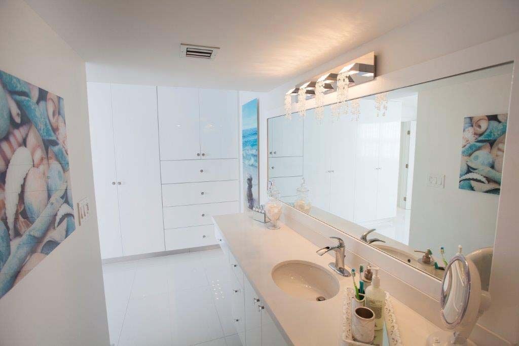 A bathroom with two sinks and a large mirror.