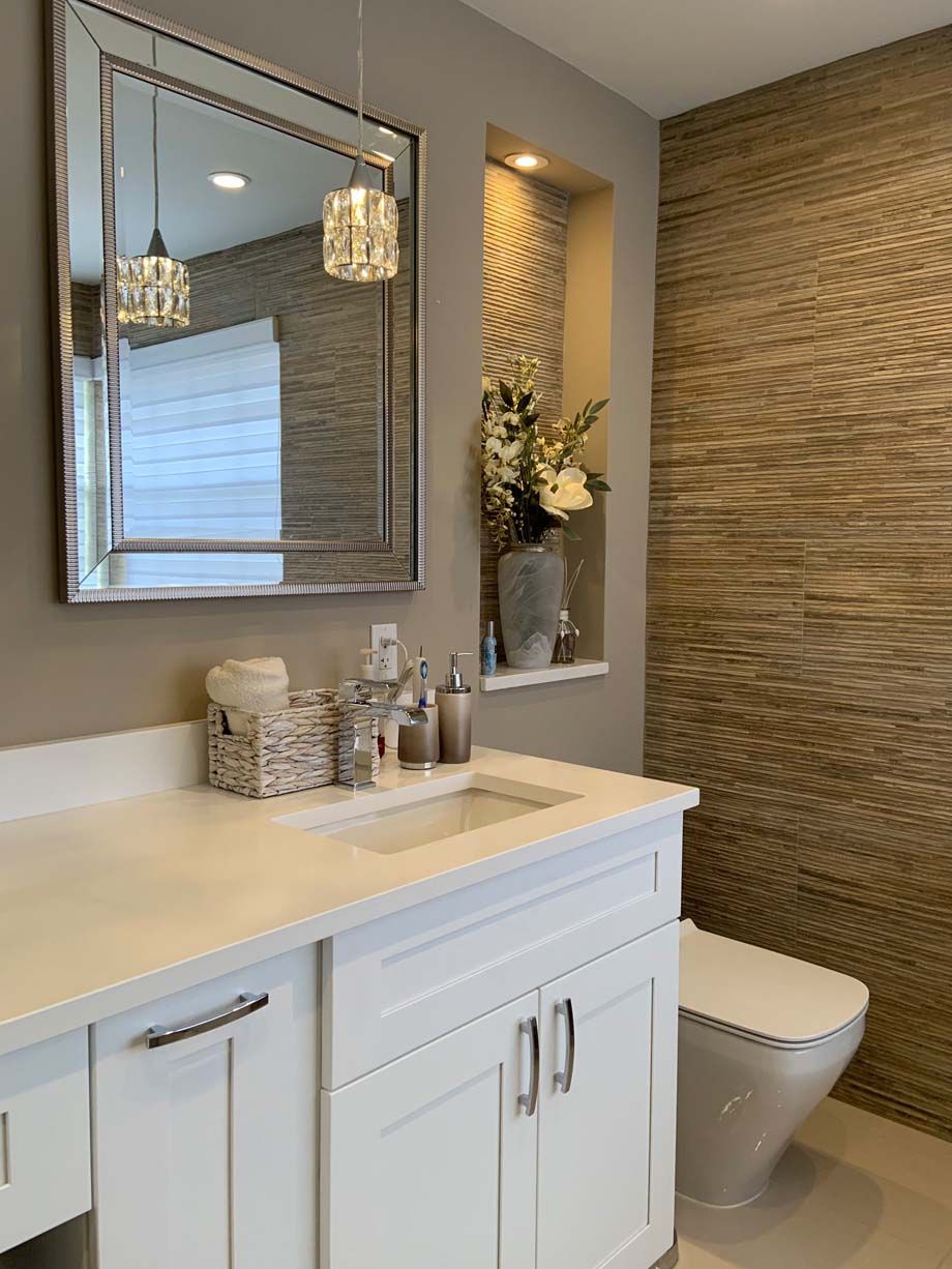 A bathroom with a sink , toilet and mirror.
