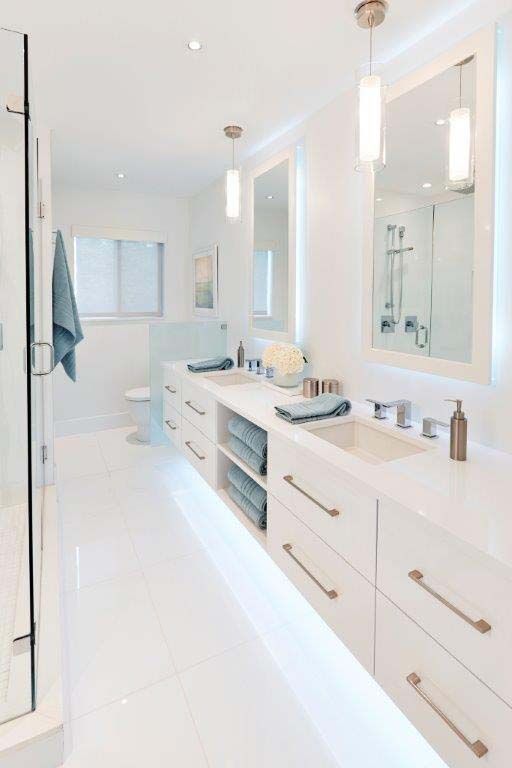 A bathroom with two sinks and two mirrors