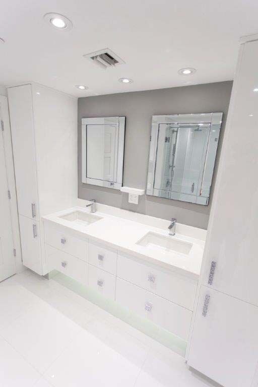 A bathroom with two sinks and two mirrors.