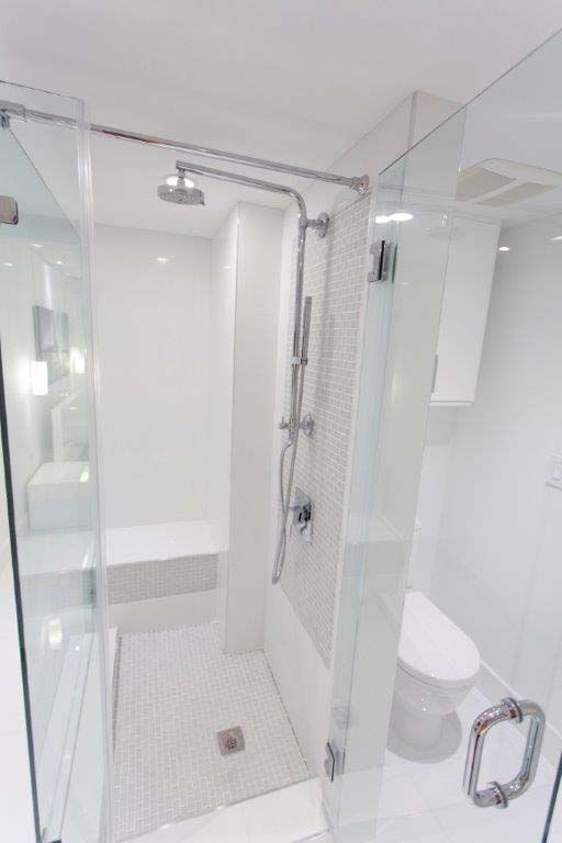 A bathroom with a walk in shower and a toilet.