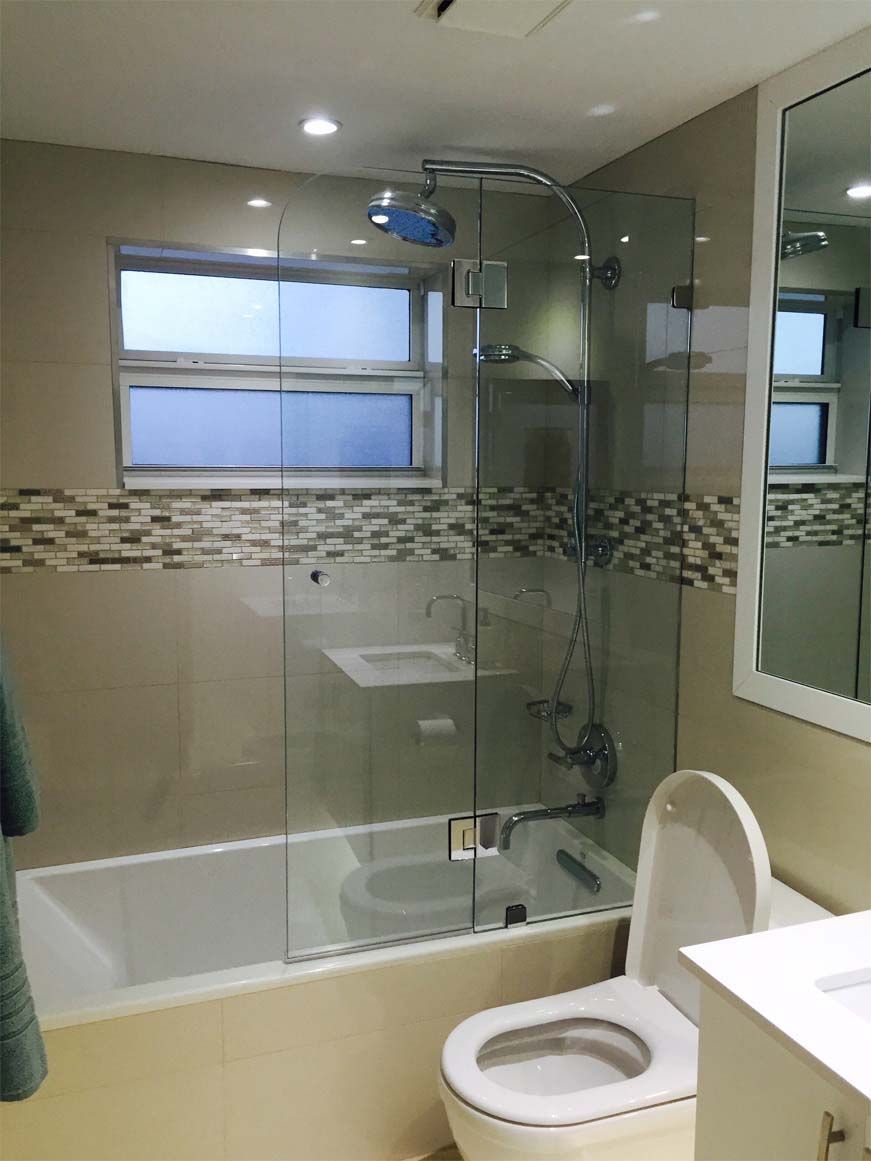 A bathroom with a toilet a tub and a shower