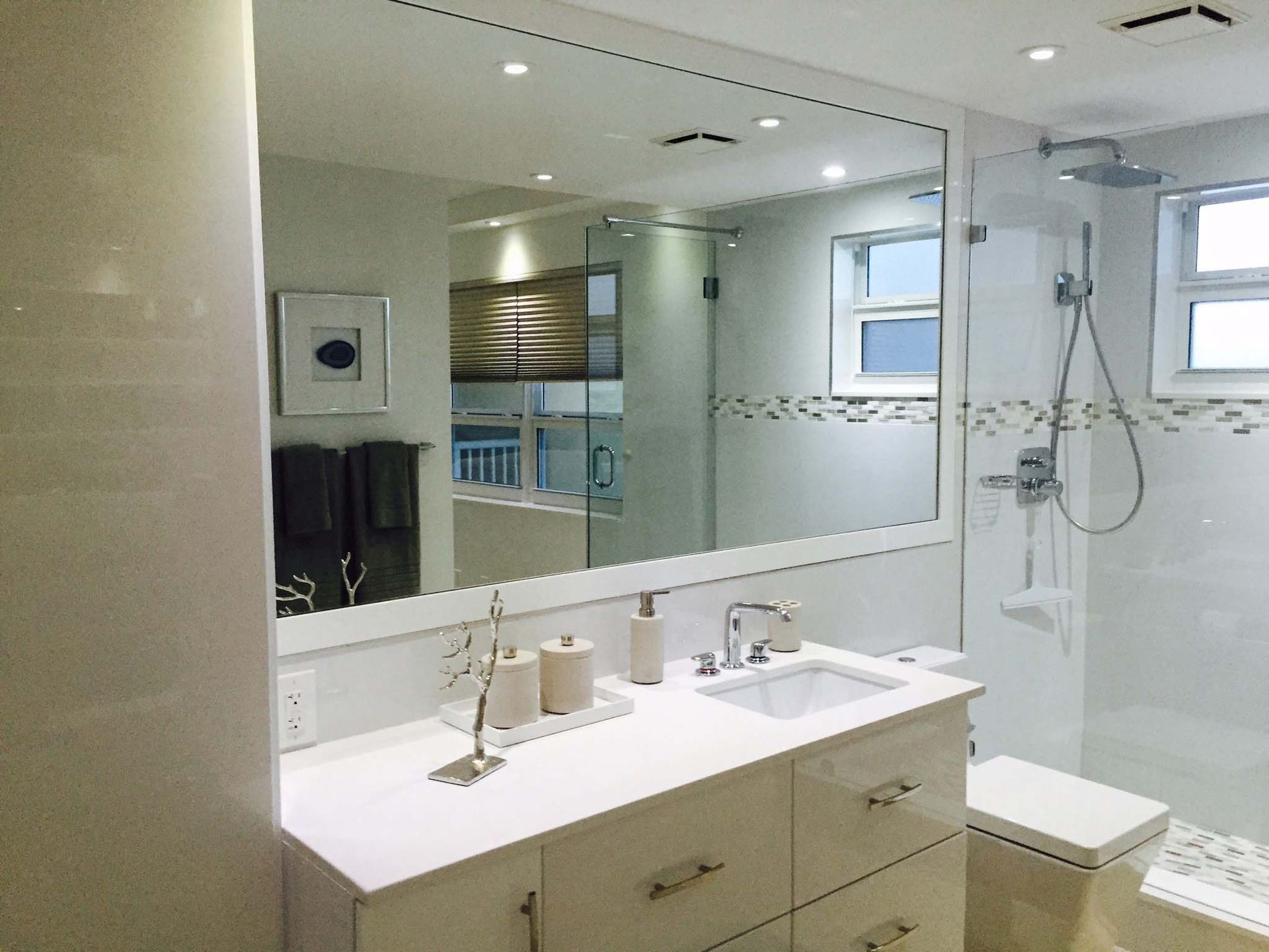 A bathroom with a sink and a large mirror