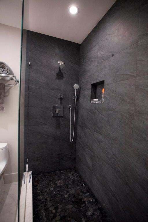 A bathroom with a walk in shower and a toilet.