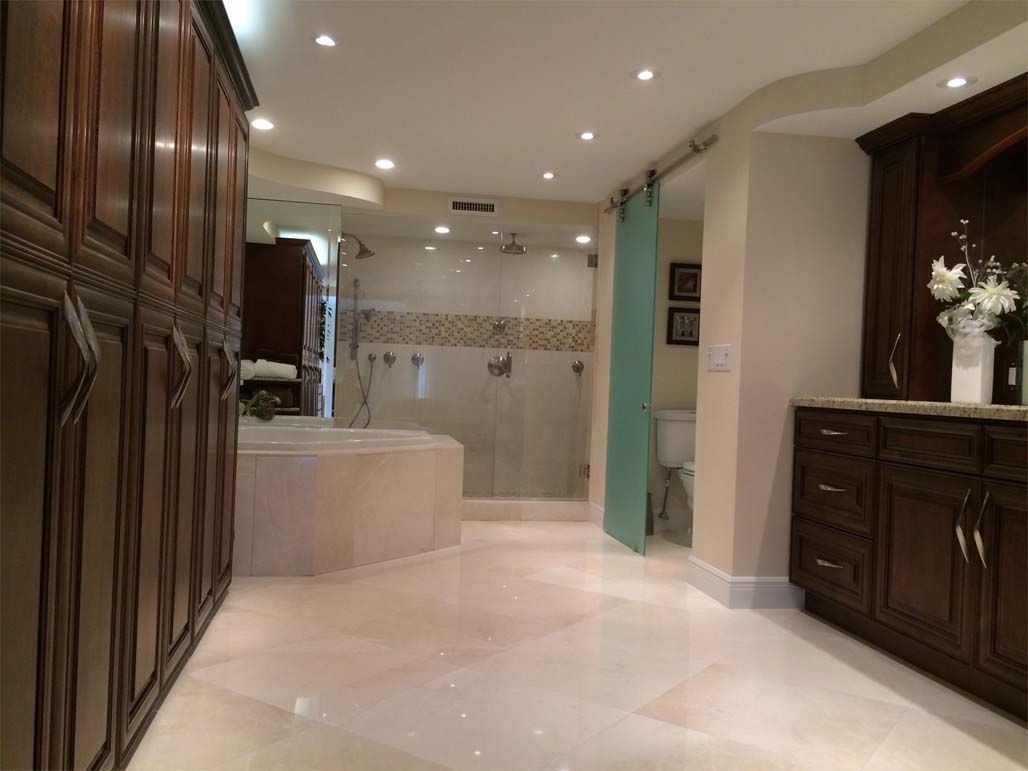 A bathroom with a sliding glass door and a bathtub