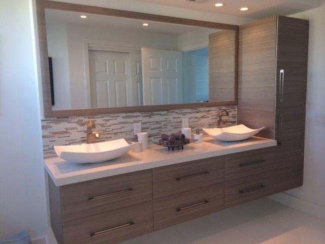 A bathroom with two sinks and a large mirror.
