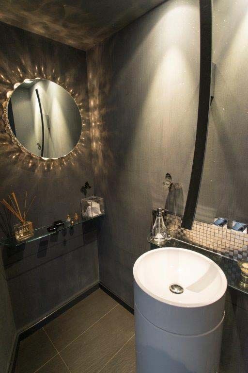 A bathroom with a sink and a mirror on the wall.