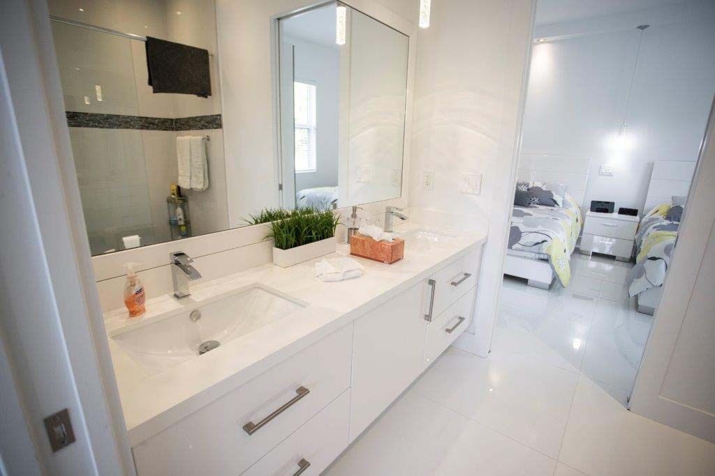A bathroom with two sinks and a large mirror.