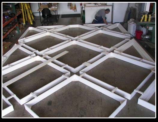 A man is working on a large grid of white squares