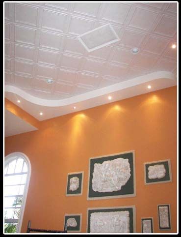 A living room with orange walls and a white ceiling