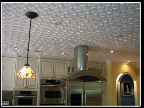 A kitchen with stainless steel appliances and a ceiling fan.