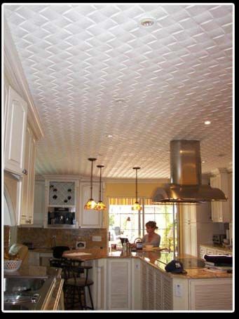 A kitchen with white cabinets and a white ceiling