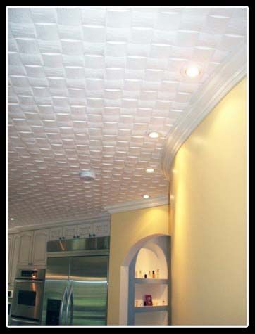 A kitchen with a white ceiling and yellow walls