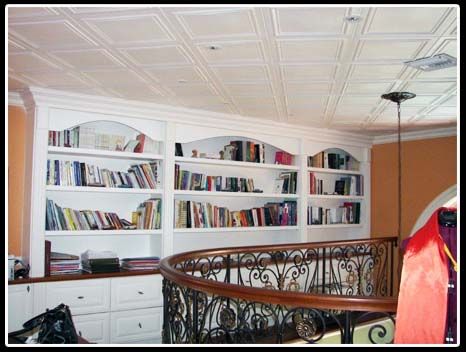 A room with a spiral staircase and shelves filled with books