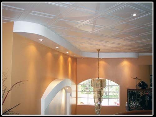 A living room with a chandelier hanging from the ceiling