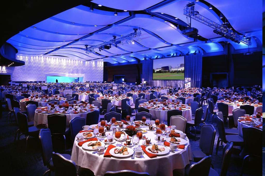 A large room with tables and chairs set up for a banquet