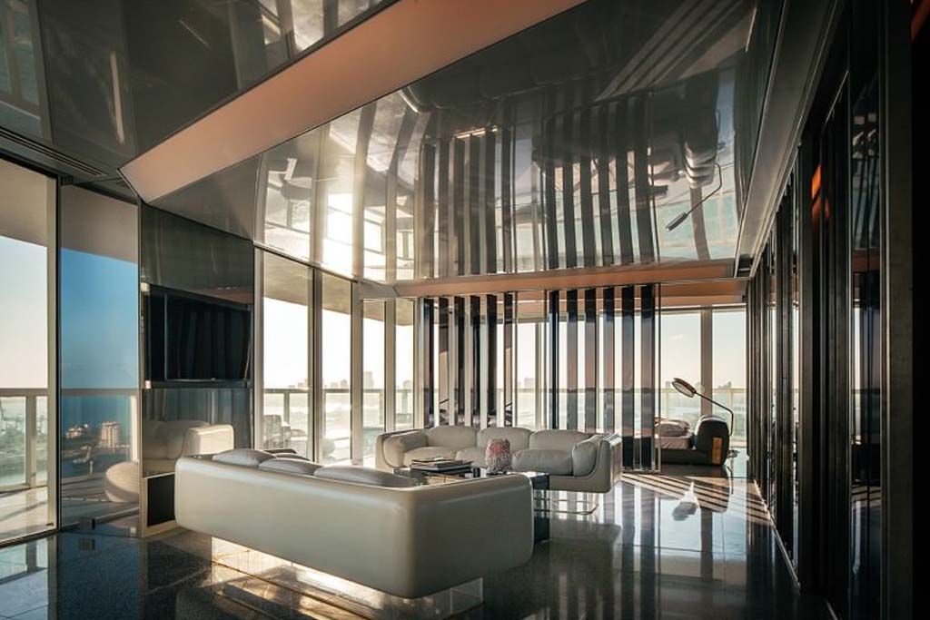 A living room with a couch and a lot of windows