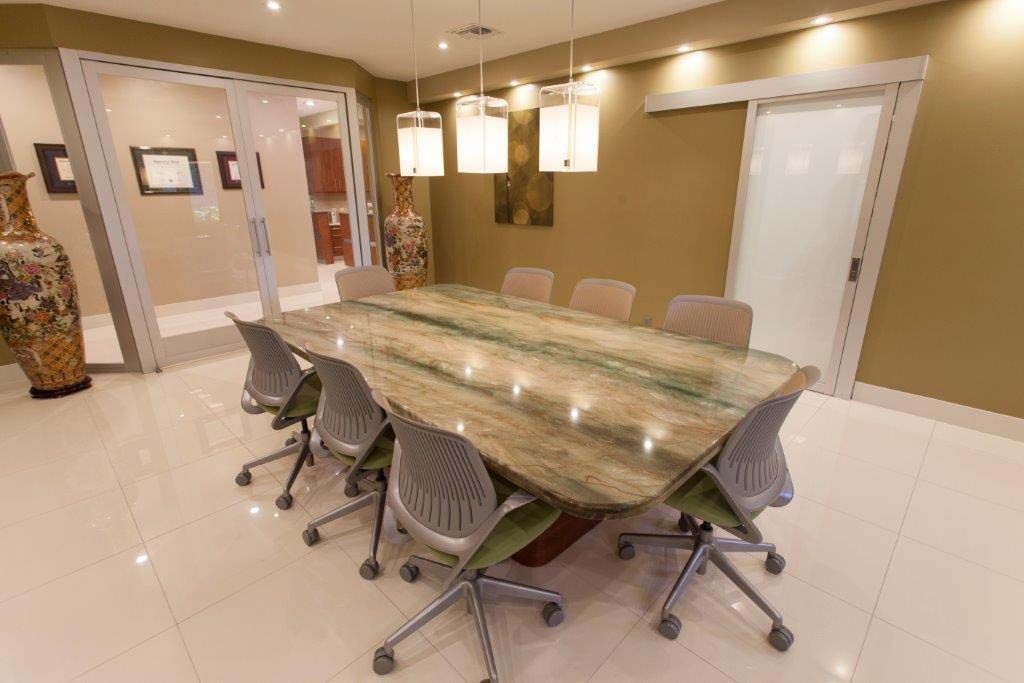 A conference room with a long table and chairs.