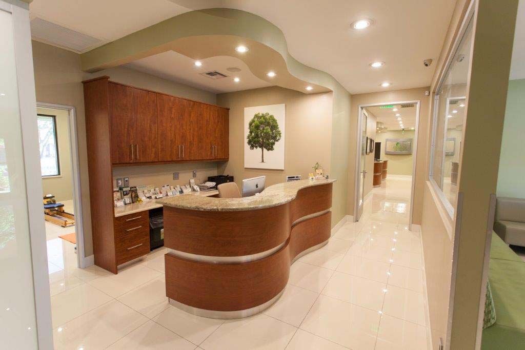 A dental office with a long hallway and a reception desk.